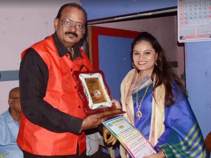 Founder being felicitated with a memento at a music event