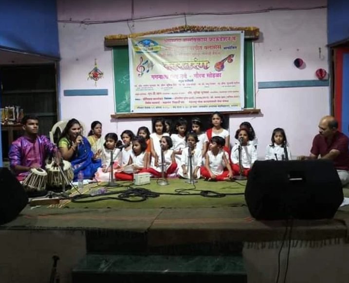 Young students performing a choir with harmonium accompaniment